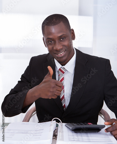 Photo: Businessman Calculating Finance Businessman Calculating Finance
