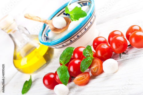 Photo: Mozzarella, tomatoes and bread. Italian food Mozzarella, tomatoes and bread. Italian food