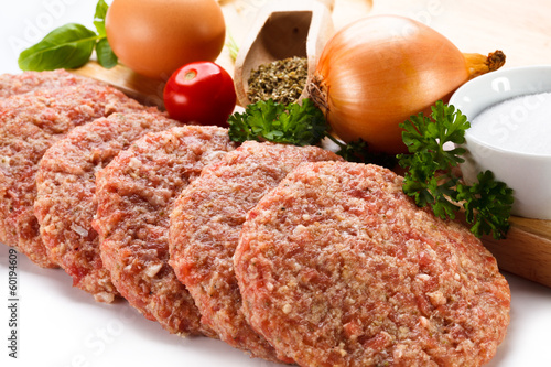 Photo: Raw minced pork chops meat on white background Raw minced pork chops meat on white background