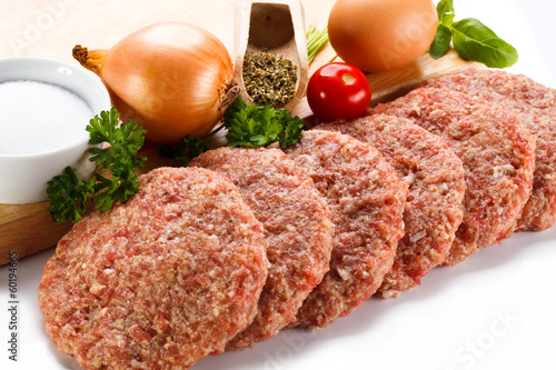 Photo: Raw minced pork chops meat on white background Raw minced pork chops meat on white background