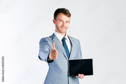 Photo: Businessman presenting tablet computer Businessman presenting tablet computer