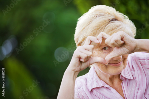 Photo: Positivity. Happy Funny Senior Woman Showing Symbol of Heart Positivity. Happy Funny Senior Woman Showing Symbol of Heart