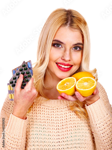 Photo: Woman having tablets and lemon. Woman having tablets and lemon.