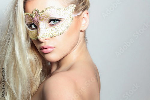 Photo: Beautiful Blond Woman in a Carnival Mask.Masquerade. Sexy Girl Beautiful Blond Woman in a Carnival Mask.Masquerade. Sexy Girl