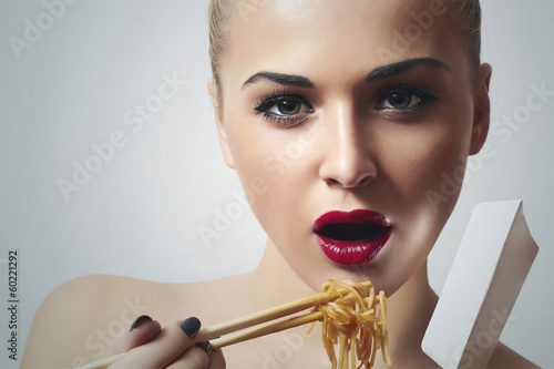 Photo: Beautiful Woman with Chinese Noodles.Red Lips.Enjoy meal Beautiful Woman with Chinese Noodles.Red Lips.Enjoy meal