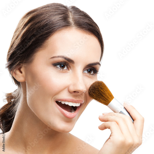 Photo: Young woman with cosmetics brush, isolated Young woman with cosmetics brush, isolated