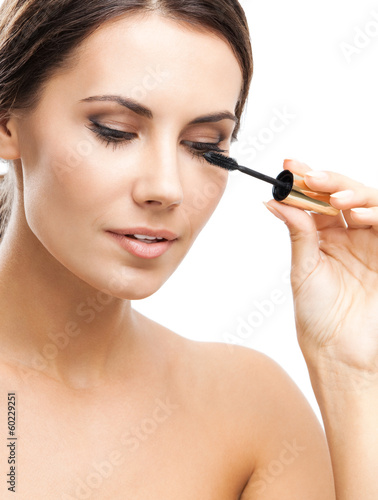 Photo: Young woman with cosmetics brush, isolated Young woman with cosmetics brush, isolated