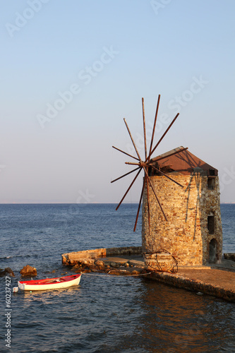 Photo: Old Greek Windmill and Wooden Boat Old Greek Windmill and Wooden Boat