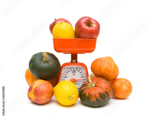 Photo: fruits, vegetables and kitchen scale on white background fruits, vegetables and kitchen scale on white background