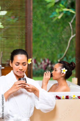 Photo: Indonesian women having wellness bath drinking tea Indonesian women having wellness bath drinking tea