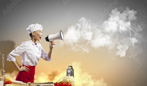 Photo: Asian female cook holding megaphone Asian female cook holding megaphone