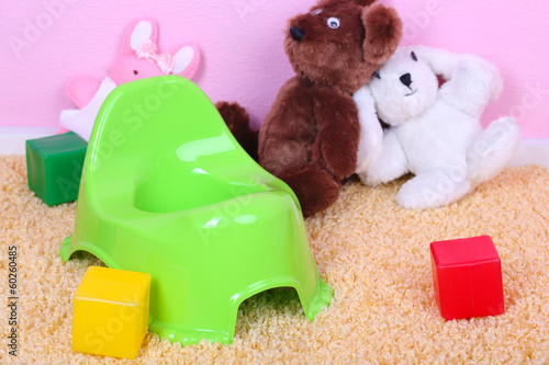 Photo: Green potty on home interior background Green potty on home interior background