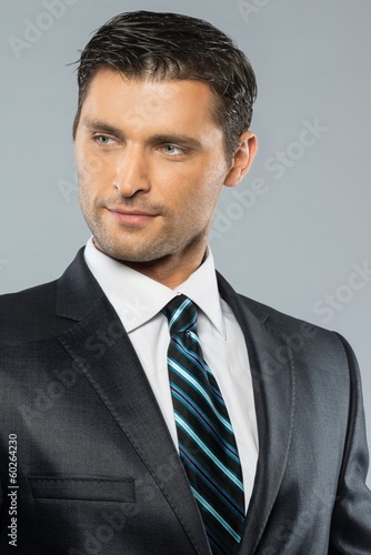 Photo: Well-dressed handsome man in black suit and tie Well-dressed handsome man in black suit and tie
