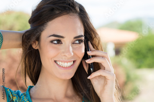 Photo: Smiling Woman Talking On Cellphone Smiling Woman Talking On Cellphone