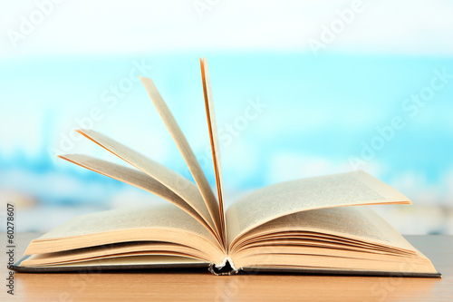 Photo: Opened book on bright background Opened book on bright background