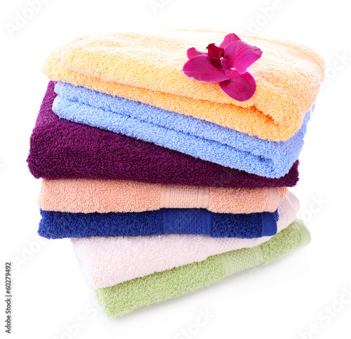Photo: Orchid flower and towels, isolated on white Orchid flower and towels, isolated on white