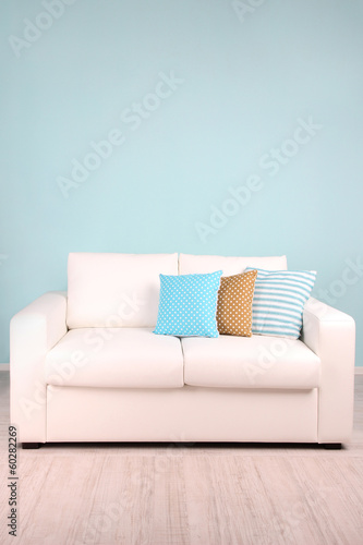 Photo: White sofa in room on blue background White sofa in room on blue background