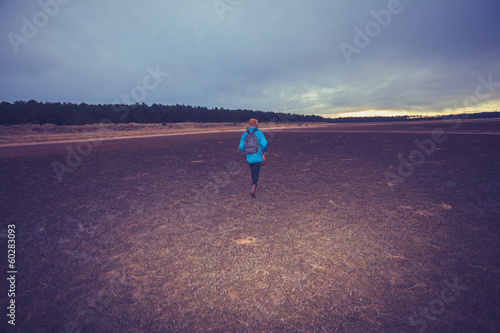 Photo: Hiker walking across a wet terrain Hiker walking across a wet terrain