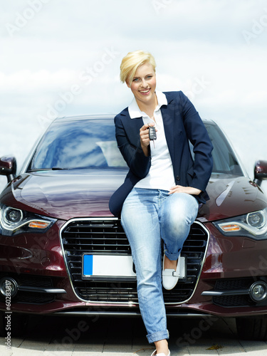 Photo: Woman proudly presents the key of her car Woman proudly presents the key of her car