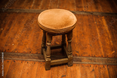 Photo: Antique stool on wooden floor Antique stool on wooden floor