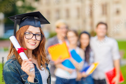 Photo: smiling teenage girl in corner-cap with diploma smiling teenage girl in corner-cap with diploma