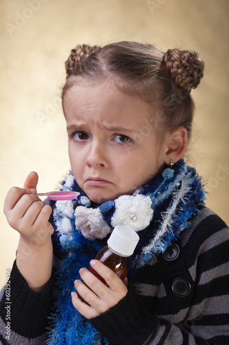 Photo: Little girl does not like cough syrup Little girl does not like cough syrup