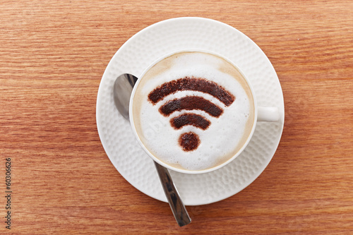 Photo: Free wifi area sign on a latte coffee Free wifi area sign on a latte coffee