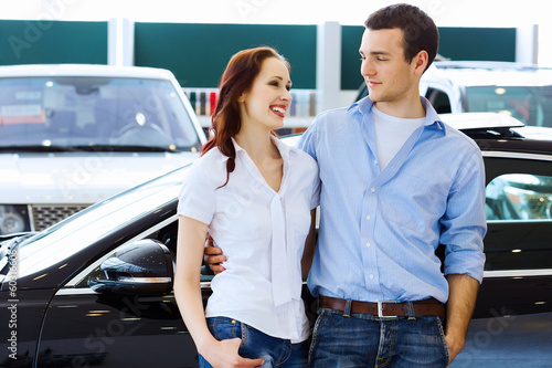 Photo: Young happy couple at car salon Young happy couple at car salon