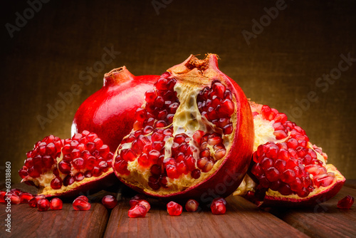 Photo: red pomegranate fruits on a dark background red pomegranate fruits on a dark background