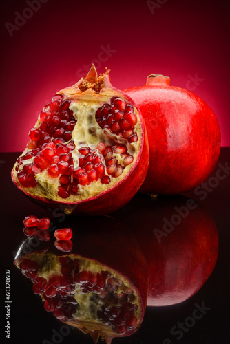 Photo: red pomegranate fruits on a dark background red pomegranate fruits on a dark background