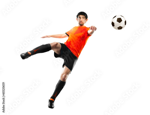 Photo: football player striking the ball, isolated football player striking the ball, isolated
