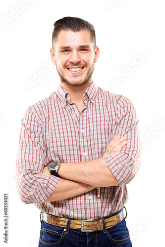 Photo: Casual young man looking at camera with arms crossed Casual young man looking at camera with arms crossed