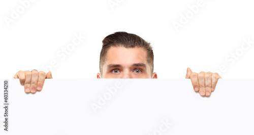 Photo: shocked businessman holding a blank white card board, signboard shocked businessman holding a blank white card board, signboard