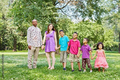 Photo: Mixed race family of six stands according to height Mixed race family of six stands according to height