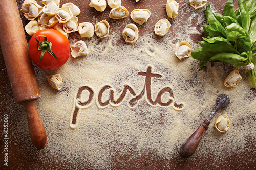 Photo: Pasta word written on table Pasta word written on table