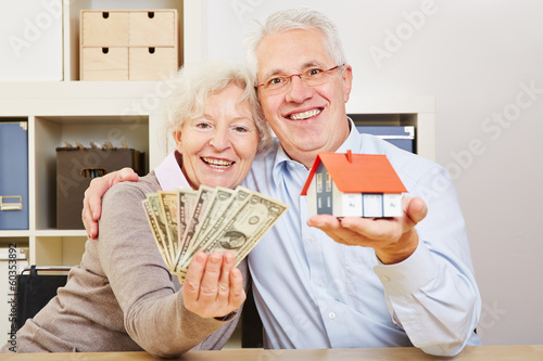 Photo: Glückliche Senioren mit Dollar und Haus Glückliche Senioren mit Dollar und Haus