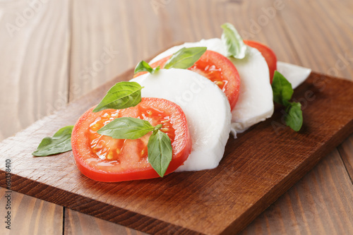 Photo: caprese salad made on cutting board caprese salad made on cutting board