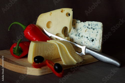 Photo: Blue cheese,cheese with holes, red pepper and knife Blue cheese,cheese with holes, red pepper and knife