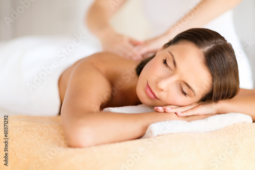 Photo: beautiful woman in spa salon getting massage beautiful woman in spa salon getting massage