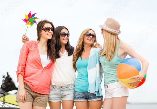 Photo: smiling girls in shades having fun on the beach smiling girls in shades having fun on the beach
