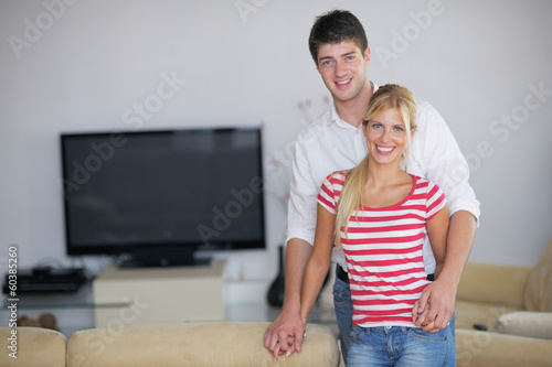 Photo: Relaxed young couple watching tv at home Relaxed young couple watching tv at home