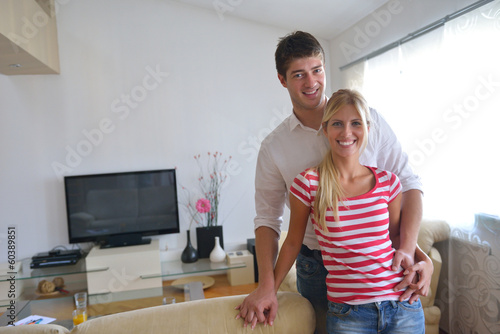 Photo: Relaxed young couple watching tv at home Relaxed young couple watching tv at home