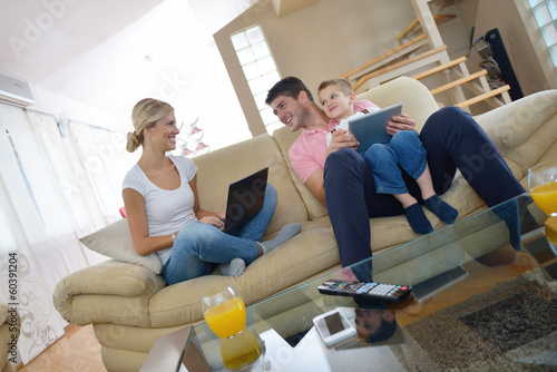 Photo: family at home using tablet computer family at home using tablet computer