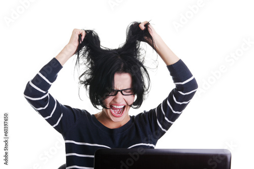 Photo: Frustrated woman working on laptop Frustrated woman working on laptop