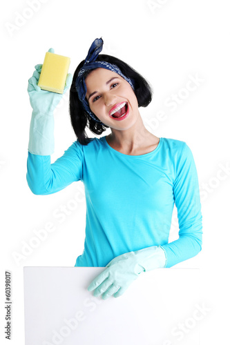 Photo: Cleaning woman showing blank sign board. Cleaning woman showing blank sign board.