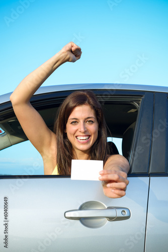 Photo: Successful girl passing car driving license test Successful girl passing car driving license test