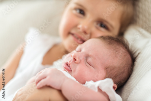Photo: Newborn in a christening dress in her sister Newborn in a christening dress in her sister