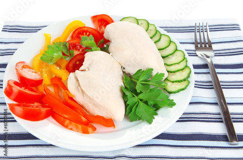 Photo: Boiled chicken breast on plate with vegetables close up Boiled chicken breast on plate with vegetables close up