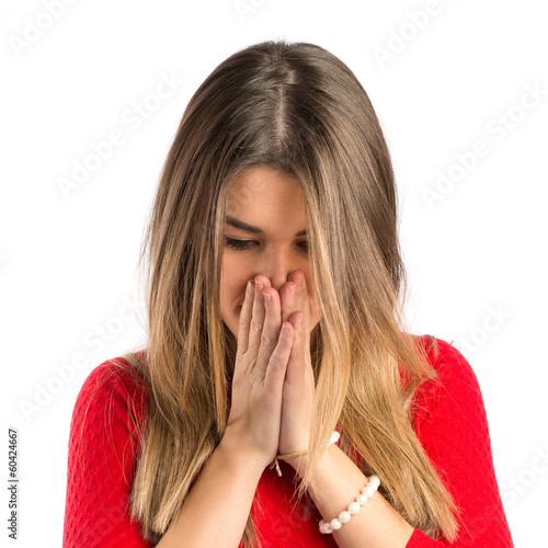 Photo: Young girl pleading over white background Young girl pleading over white background