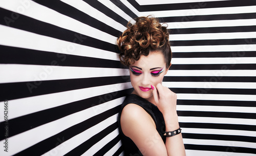 Photo: Beautiful young woman with professional party make up Beautiful young woman with professional party make up